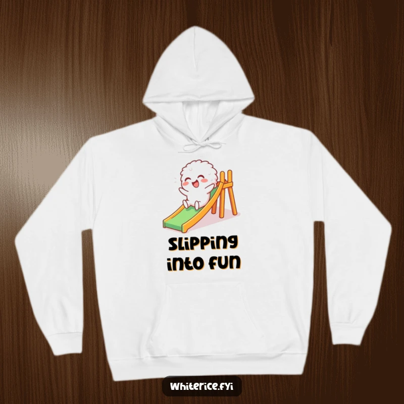 Funny hoodie featuring a giggling white rice character descending a miniature slide, radiating happiness and a playful, humorous spirit for ultimate coziness.